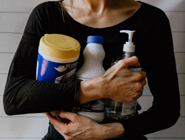 woman gathering cleaning supplies